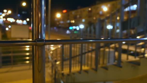 Abstract blurred background. night city with steel railings near the city road — Stock Video