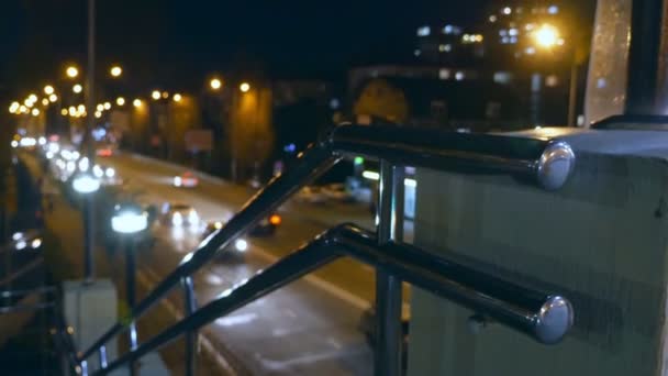 Abstract blurred background. night city with steel railings near the city road — Stock Video