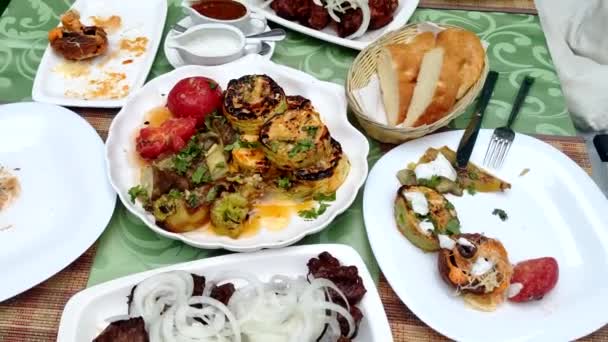 Close-up. Cooked kebabs with onions with vegetables and grilled mushrooms. on the table in the restaurant — Stock Video
