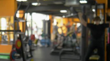 bulanık arka plan, spor salonunun genel planı. sporcular simülatörleri üst ve alt blok çekiş yapmak