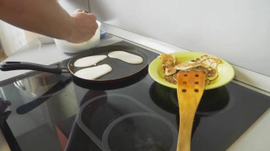 Yaklaş, birisi tencerede krep pişiriyor.