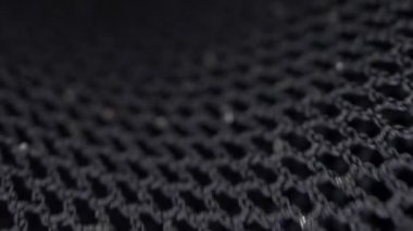 Makro. Tekstil arka planı. Siyah guipure kumaşın lurex ile hareketi