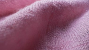 Süper yakın çekim. Pembe örülmüş yün kumaşın ayrıntıları. tekstil arkaplanı