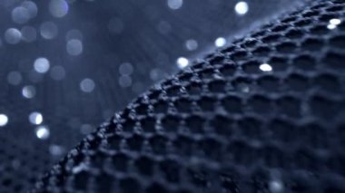 Makro. Tekstil arka planı. Siyah guipure kumaş harfi ile lurex, bulanık