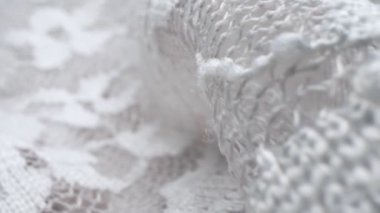 Makro. Tekstil arka planı. Dantel kumaş kıvrımları