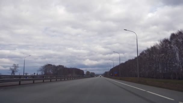 Άδειος αυτοκινητόδρομος σε ένα χωράφι. τον ορίζοντα και τα βροντερά σύννεφα — Αρχείο Βίντεο