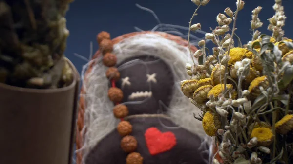 Super close up. details of a voodoo doll and bunches of dried herbs in a basket — Stock Photo, Image