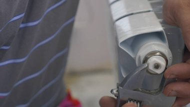 İnsan eli yaklaş. İşçi kurulum için bimetalik radyatör hazırlar