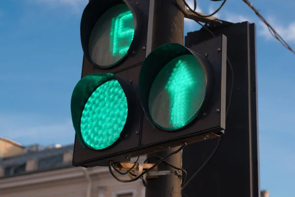 Green traffic light with timer and arrow