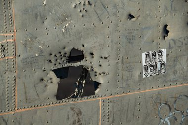 Close up photo of bullet marks on the Abandoned DC Plane's fuselage on Solheimasandur, Iceland clipart