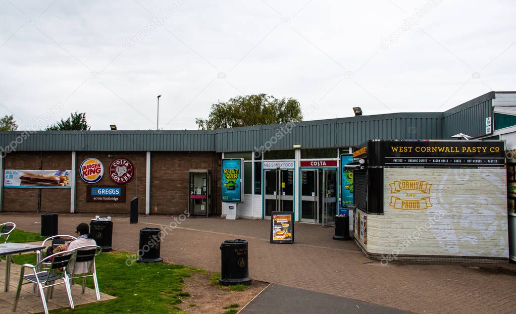 Carlisle, United Kingdom - August 11 2018:   A grey day at Southwaite service station southbound, with signs for Burger King, M&S Simply food, Costa Coffee, Greggs and The West Cornwall Pasty Co