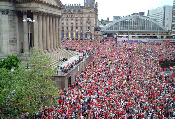 26th May, 2005, Liverpool UK. Fans gather outside Lime Street station for the victory parade of  Liverpool Football Club after winning the Champions league final in Istanbul