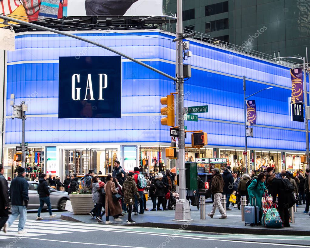 New York City, United States - November 17 2018:   The neon lit frontage of the Gap clothing store on the corner of Boradway and  West 44th Street