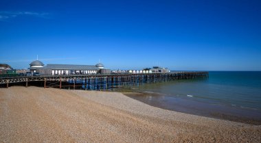 Hastings pier stretches into the English Channel on a sunny summer day clipart