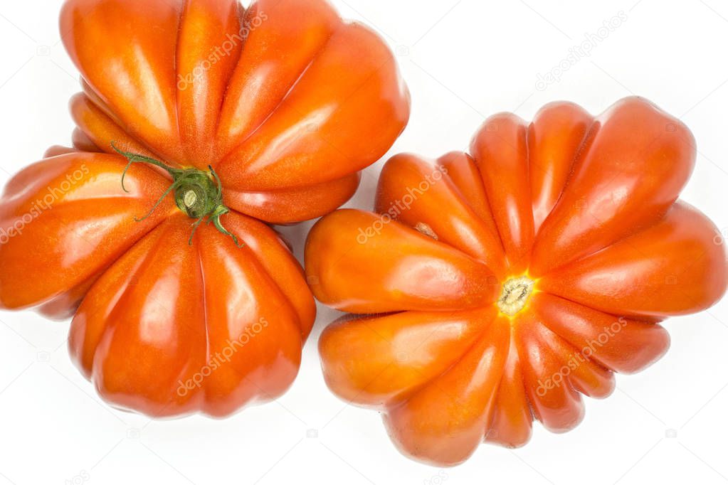 Two beef tomatoes (butterfly and flower shapes) top view isolated on white background one big ripe red ribbing flatla
