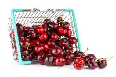 Sweet bright red cherry out of a shopping basket isolated on whit clipart