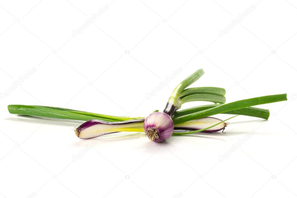 Group of one whole two halves of fresh green spring onion red scallion variety isolated on white