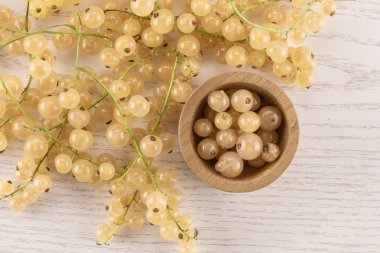 Bütün taze beyaz üzümü berry blanka çeşitli ve ahşap kase çilek flatlay gri Wood dolu çok