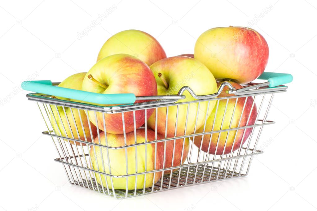 Lot of whole fresh red apple james grieve variety with shopping basket isolated on white background