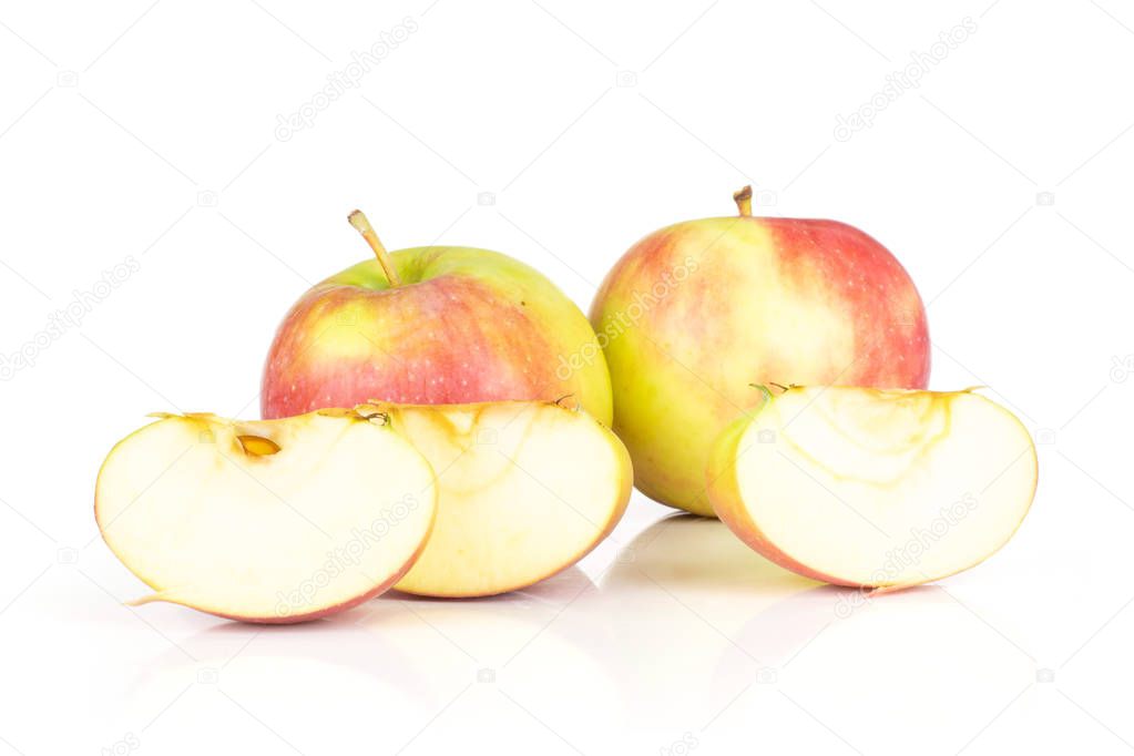 Group of two whole three slices of fresh red apple james grieve variety isolated on white background
