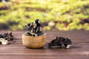 Dry black mushroom jew ear with forest behind clipart