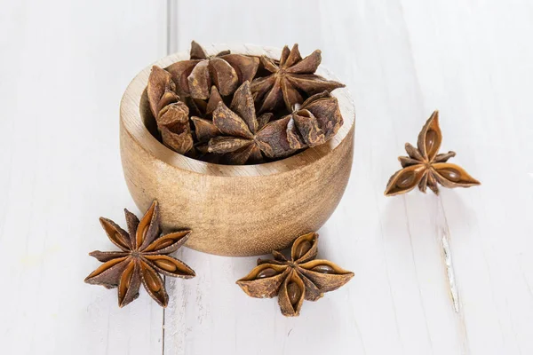 Dry brown star anise fruit on grey wood