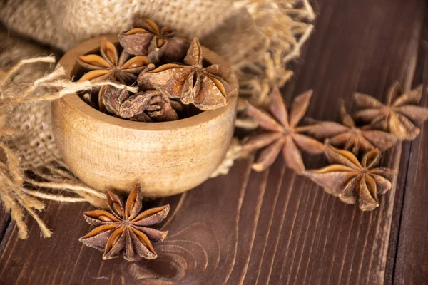 Dry brown star anise fruit on brown wood
