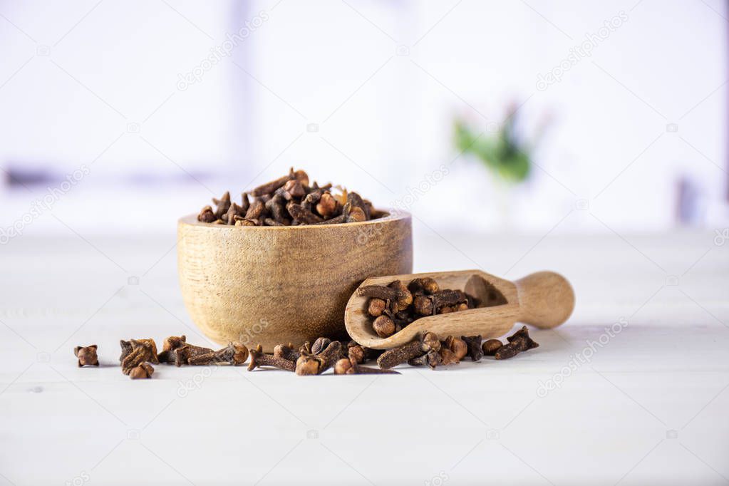 Small dried cloves spice with red tulips