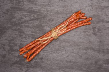 Baharatlı tyrolini salam sopa üzerinde gri taş