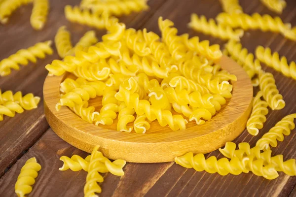 Raw italian torti pasta on brown wood — Stock Photo, Image