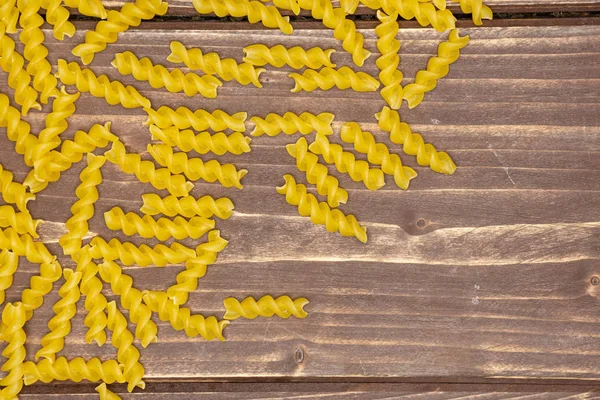 Raw italian torti pasta on brown wood — Stock Photo, Image