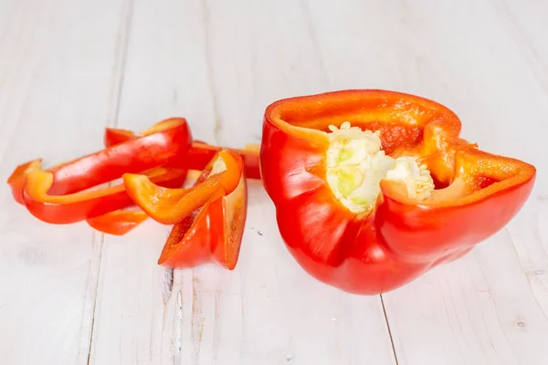 Fresh red paprika on grey wood — Stock Photo, Image