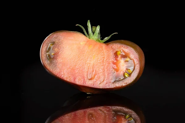 Primula fresca di pomodoro scuro isolata su vetro nero — Foto Stock