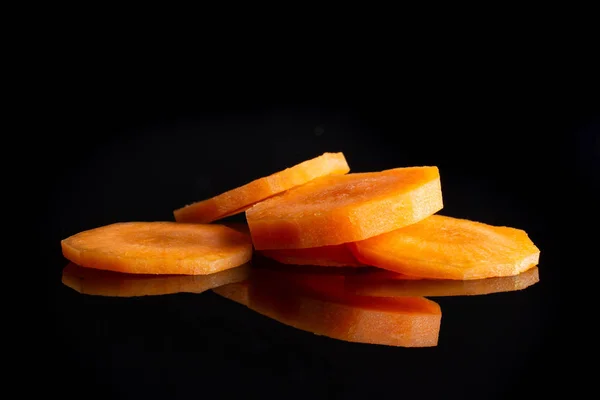 Свіжа апельсинова морква ізольована на чорному склі — стокове фото