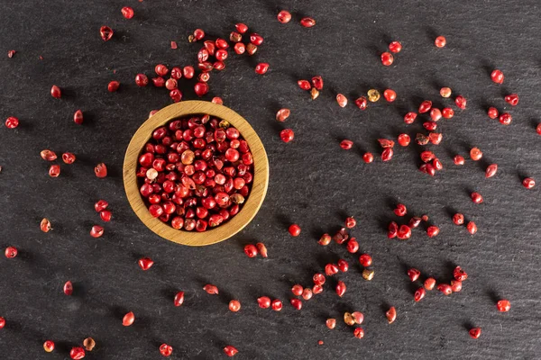 Pink peruvian pepper on grey stone