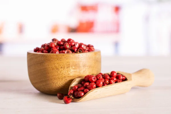 Pink peruvian pepper with kitchen behind