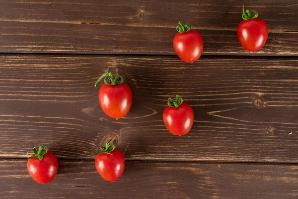 Red cherry tomato on brown wood