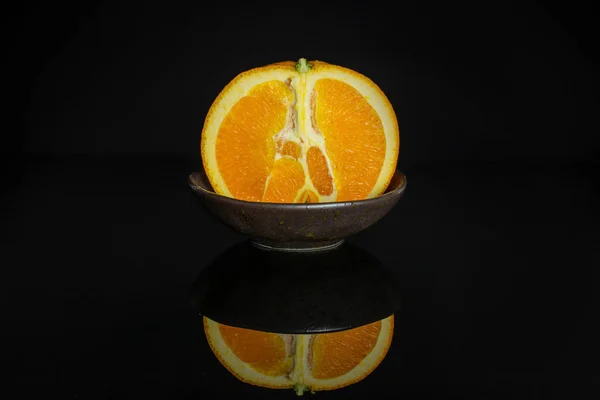 Sweet orange isolated on black glass — Stock Photo, Image