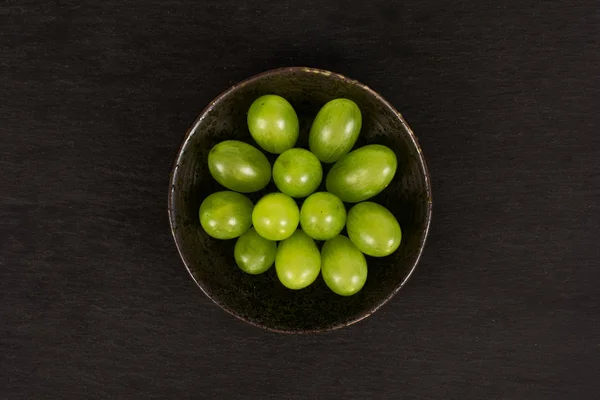 Fresh green grape on grey stone — Stock Photo, Image