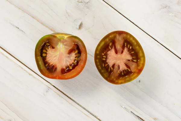 Greenish red tomato on grey wood — Stock Photo, Image