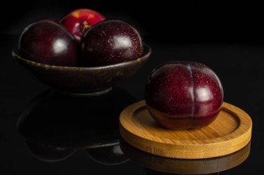 Olgun kırmızı erik siyah cam izole