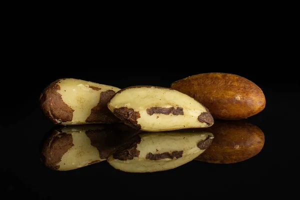 Unshelled brazil nut isolated on black glass — Stock Photo, Image