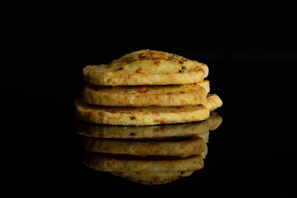 Savory cheese palmier isolated on black glass — Stock Photo, Image