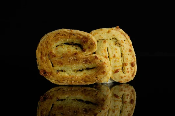 Savory cheese palmier isolated on black glass — Stock Photo, Image