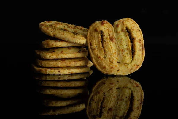 Savory cheese palmier isolated on black glass — Stock Photo, Image