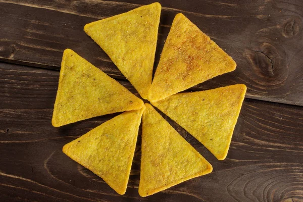 Tortilla cheese chips on brown wood — Stock Photo, Image