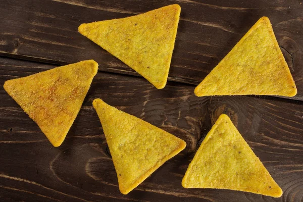 Tortilla cheese chips on brown wood — Stock Photo, Image
