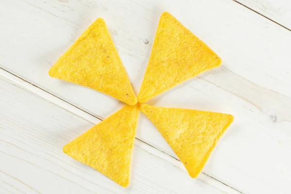 Tortilla cheese chips on grey wood — Stock Photo, Image