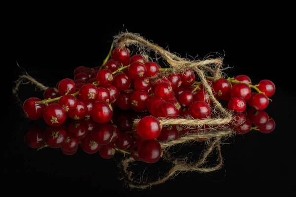 Groselha vermelha fresca isolada em vidro preto — Fotografia de Stock