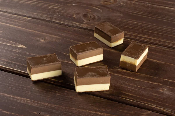 Two colours nougat on brown wood — Stock Photo, Image